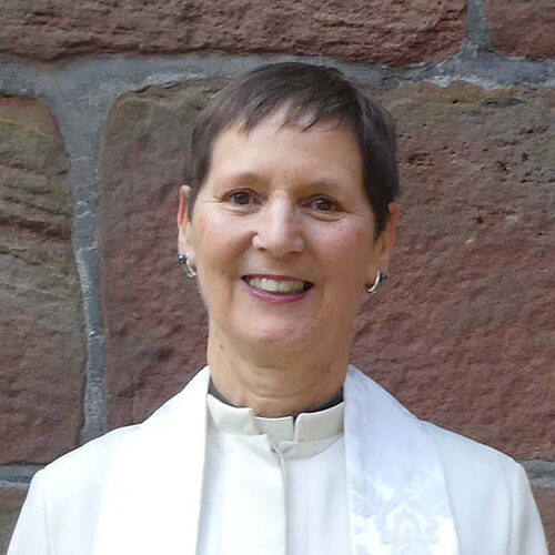 Reverend Ann Samuels, stood outside church